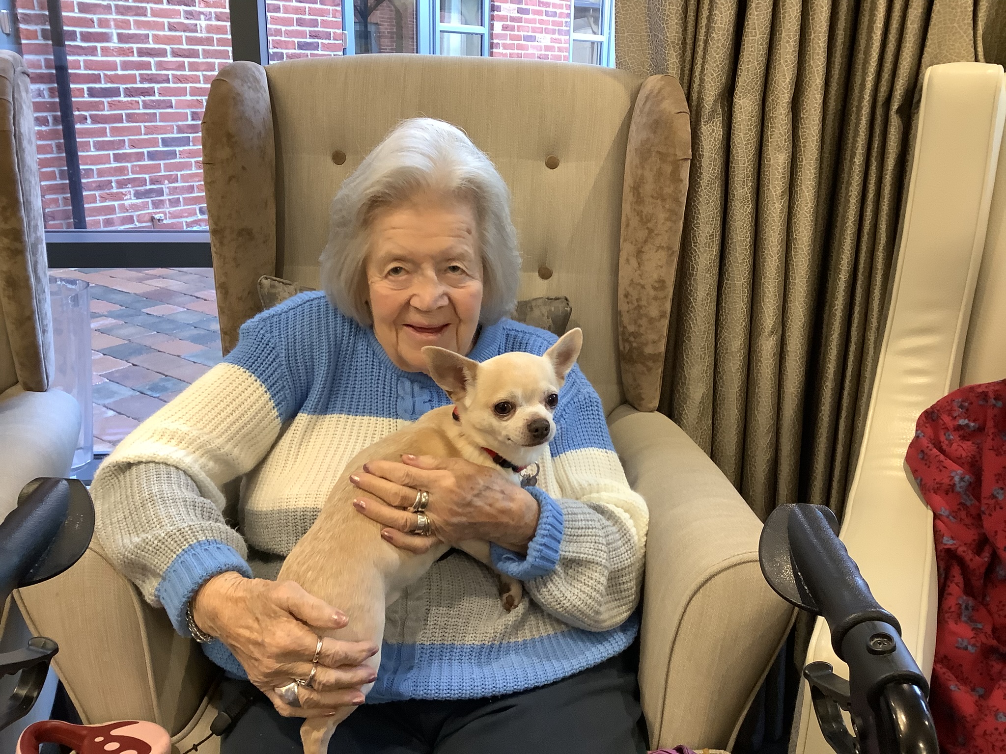 A Meadows Park resident enjoying a visit from a puppy